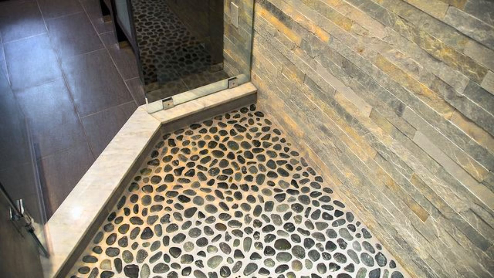 Image shows river rock shower floor.