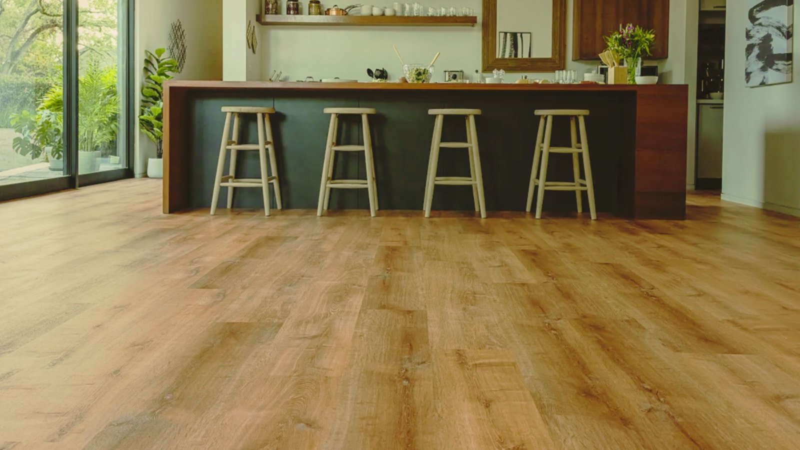 A spacious kitchen with polished wooden floors and a contemporary bar for casual meals and gatherings.