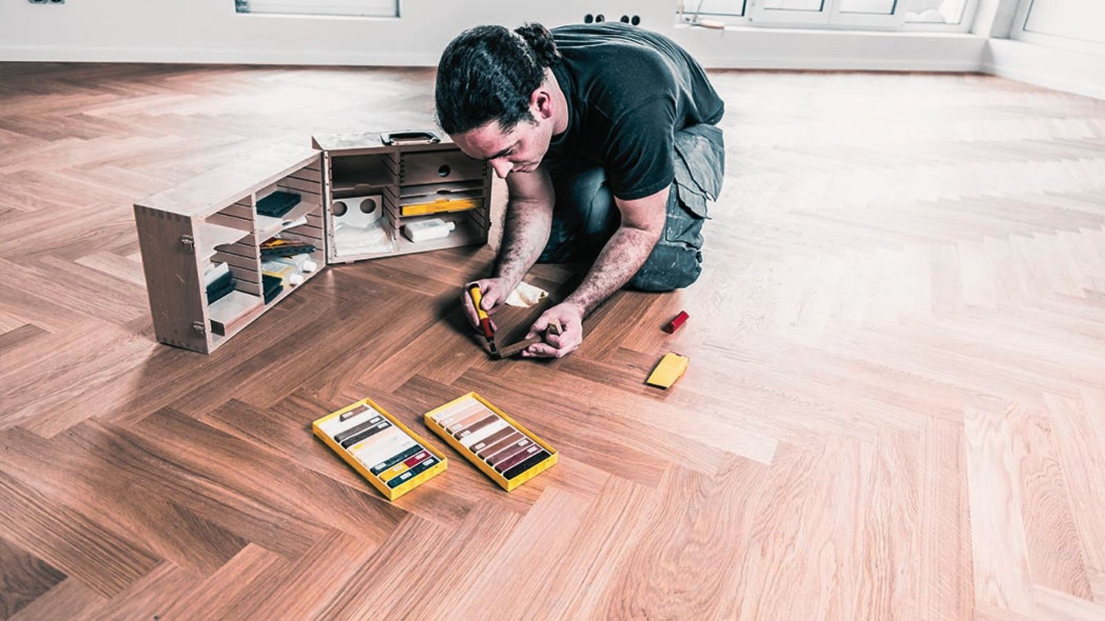Person repairing the vinyl flooring.